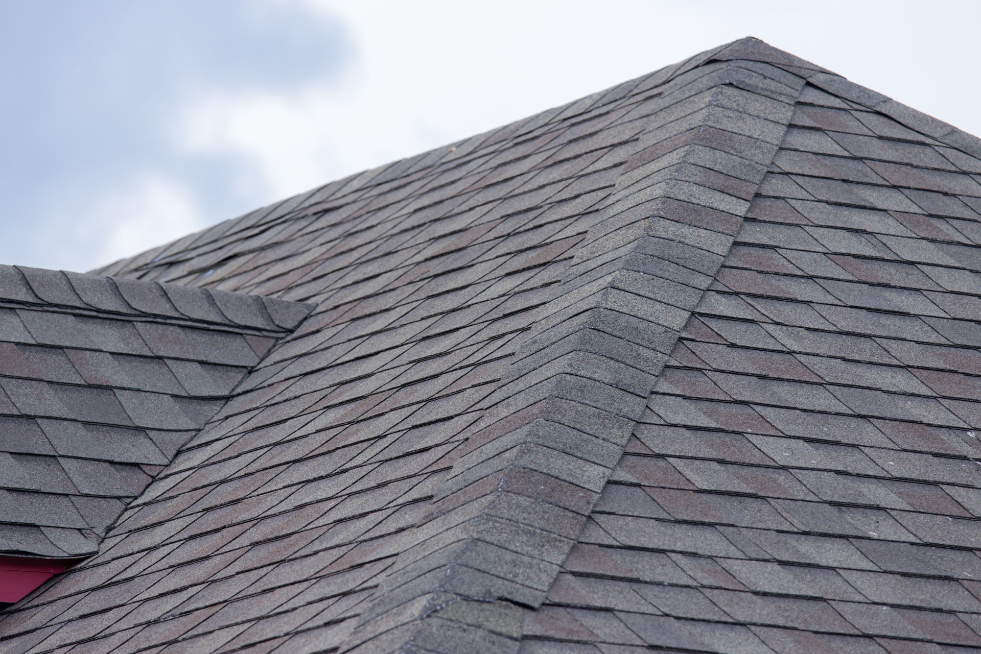 A roof with a gray and tan shingle
